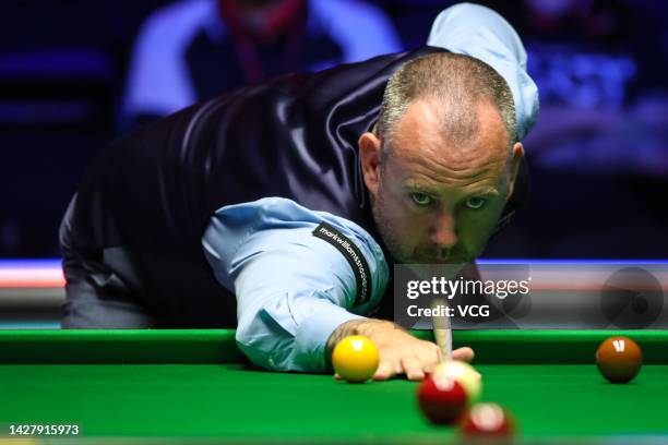 Mark Williams of Wales plays a shot in the first round match against Andres Petrov of Estonia on day one of the 2022 Cazoo British Open at Marshall...