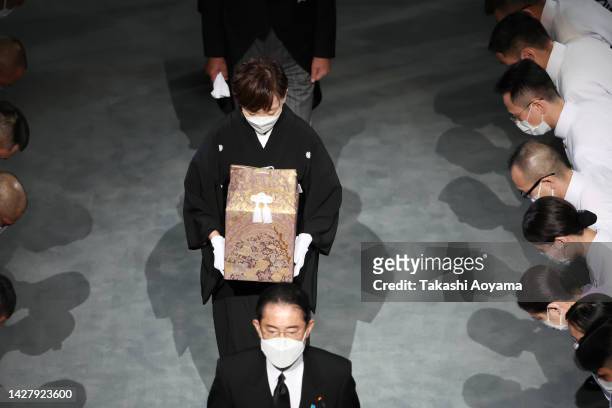 Widow of former Japanese prime minister Shinzo Abe, Akie Abe carries her husbands ashes behind Japan's Prime Minister, Fumio Kishida, during the...