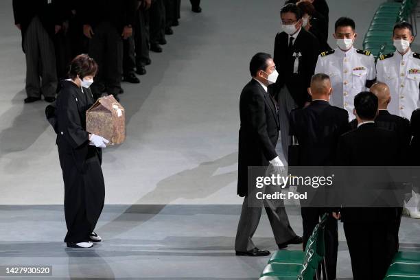 Akie Abe, wife of Japan's former prime minister Shinzo Abe , carries her husband's urn, as she leaves his state funeral on September 27, 2022 at the...