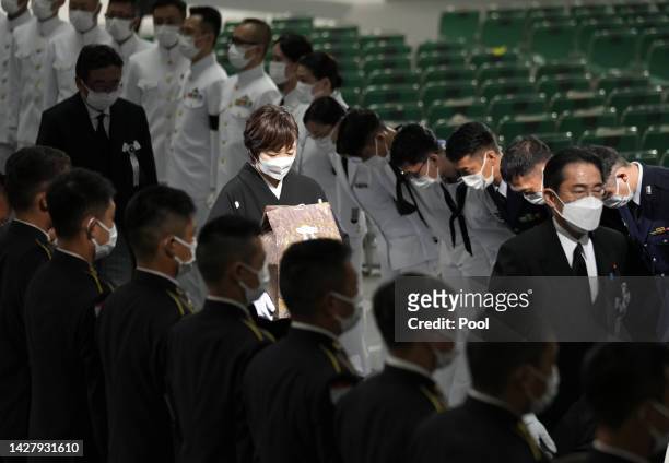 Akie Abe, wife of Japan's former prime minister Shinzo Abe , carries her husband's urn, as she leaves his state funeral on September 27, 2022 at the...