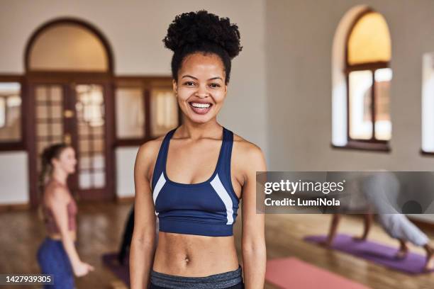 black woman, fitness and personal trainer in gym class or wellness center to workout and exercise for healthy body. african sports girl trainer smile, cardio and training in pilates or yoga studio - yogi stock pictures, royalty-free photos & images
