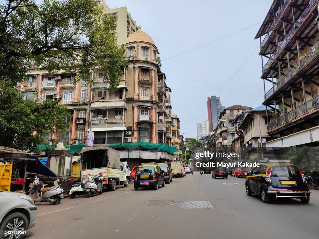 City Street By Buildings Against Sky