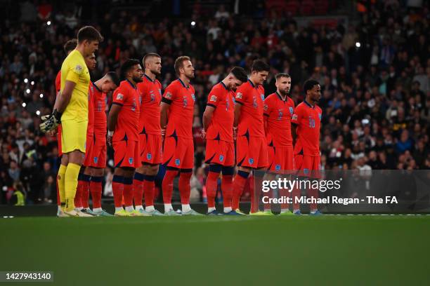 Players of England observe a minute of silence in tribute to Her Majesty Queen Elizabeth II, who passed away at Balmoral Castle on September 8 prior...