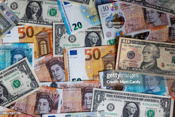 In this photo illustration, U.S. Dollar bills, British GDP and Euro currency bank notes are pictured on September 27, 2022 in Bath, England. The UK...