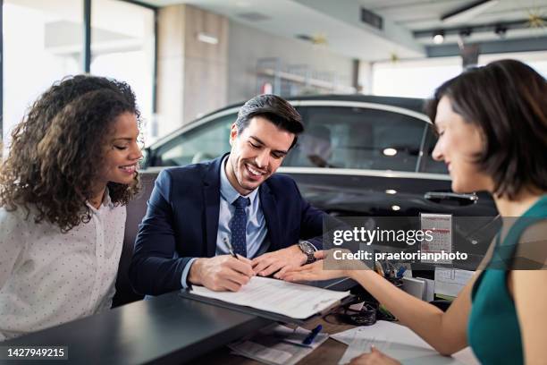 couple is buying/lease new car and signing a contract - audi showroom stock pictures, royalty-free photos & images