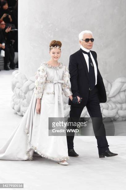 Model Devon Aoki in a Chanel bridal ensemble and Karl Lagerfeld walk the Chanel spring 2008 haute couture show finale at the Grand Palais in Paris.