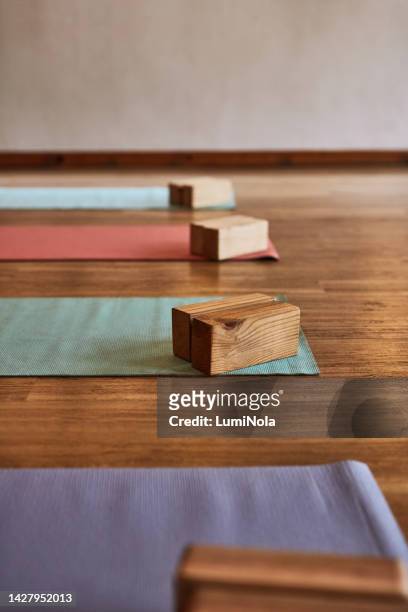 empty background of yoga blocks, mat and training on floor in fitness studio. closeup, room ground space and wooden pilates bricks equipment for wellness, gym class workout and healthy club - prop stock pictures, royalty-free photos & images