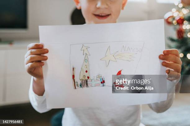 boys drawing on christmas card - santa claus lying stockfoto's en -beelden