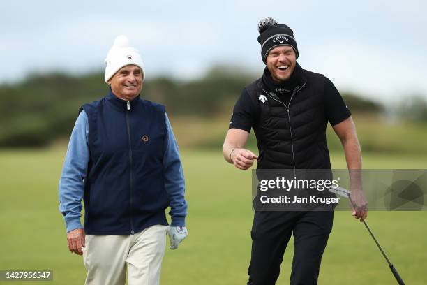 Jimmy Dunne of The United States and Danny Willett of England laugh during a practice round prior to the Alfred Dunhill Links Championship at...