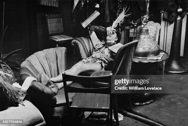 American actress Natalie Wood her hand over her face as she lies on a sofa while filming a scene for the musical 'Gypsy,' at Warner Bros' Burbank...