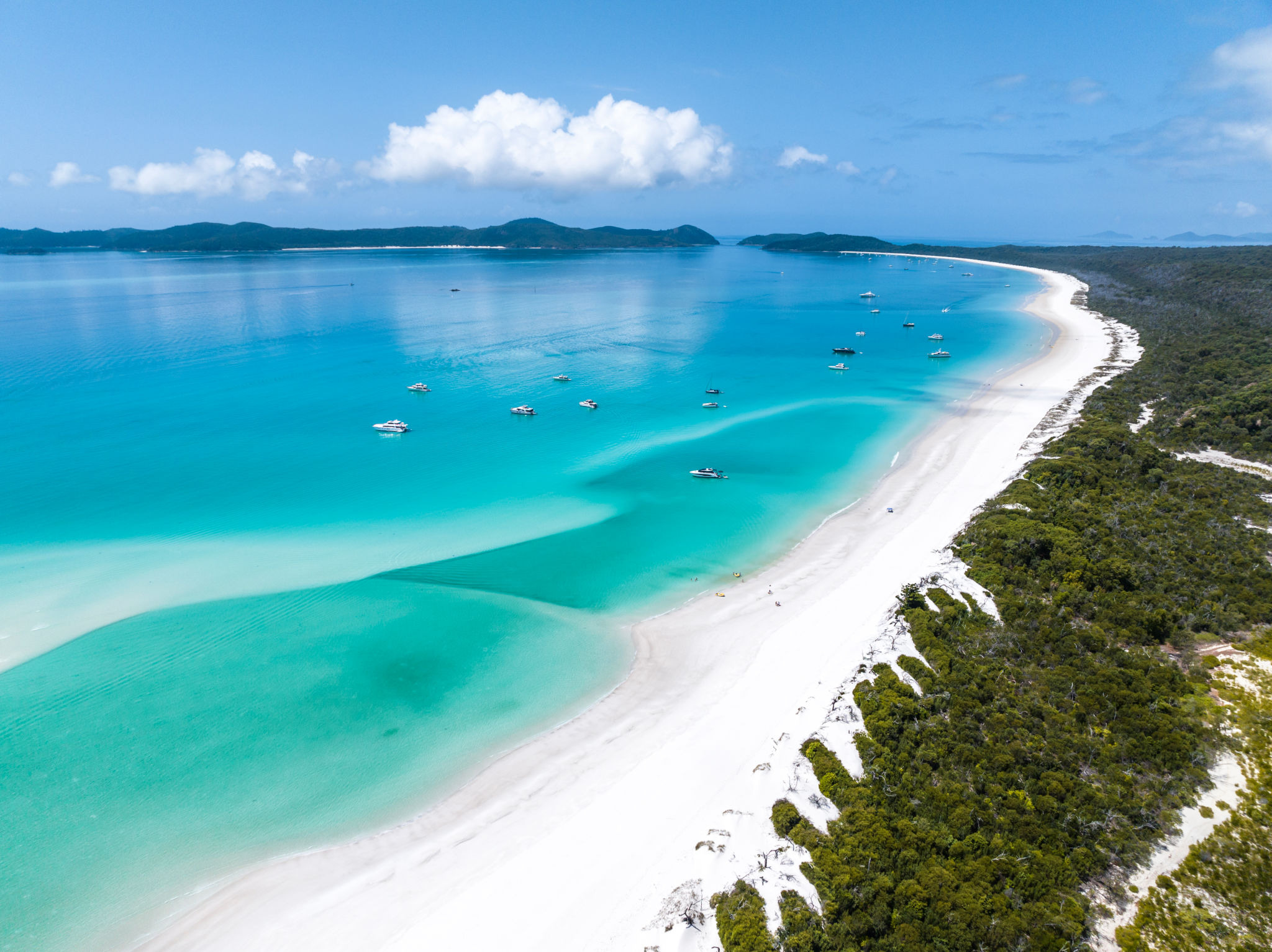 Beautiful high angle aerial drone view of famous Whitehaven Beach, part of the Whitsunday Islands National Park near the Great Barrier Reef, Queensland, Australia. Popular tourist destination. Beautiful high angle aerial drone view of famous Whitehaven Beach, part of the Whitsunday Islands National Park near the Great Barrier Reef, Queensland, Australia. Popular tourist destination.