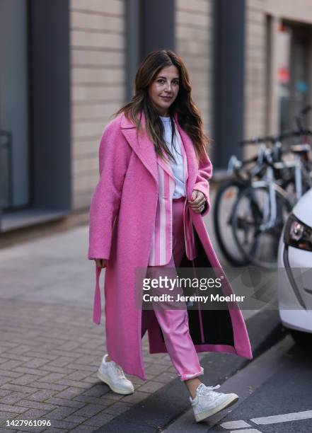 Silvia Cristina Alves Machado is seen wearing a pink Victoria Beckham long coat, pink striped vintage suit from Gianfranco Ferre Studio, white...