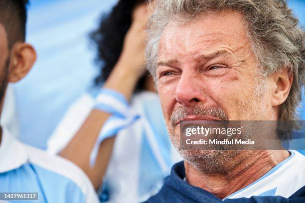 mature sport fan crying while watching match - nederlaag stockfoto's en -beelden