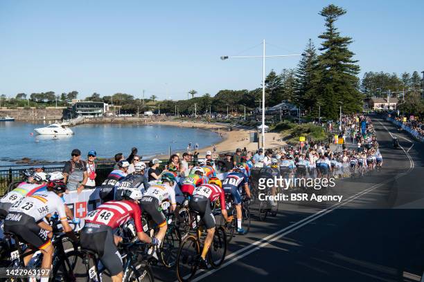The main field rides through the foreshore of the city circuit during the Men Road Race during the 95th UCI Road World Championships 2022 on...