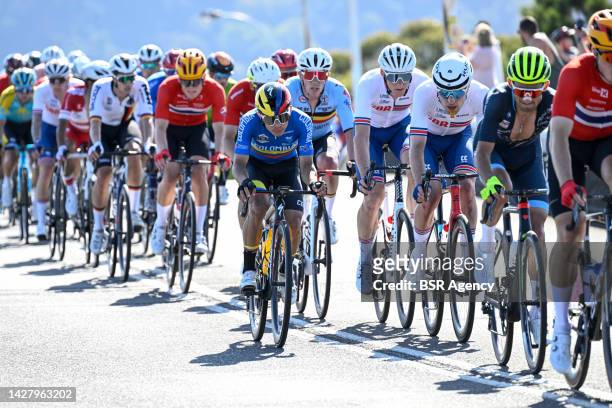 Riders in the peloton racing on the city circuit during the Men Road Race during the 95th UCI Road World Championships 2022 on September 25, 2022 in...