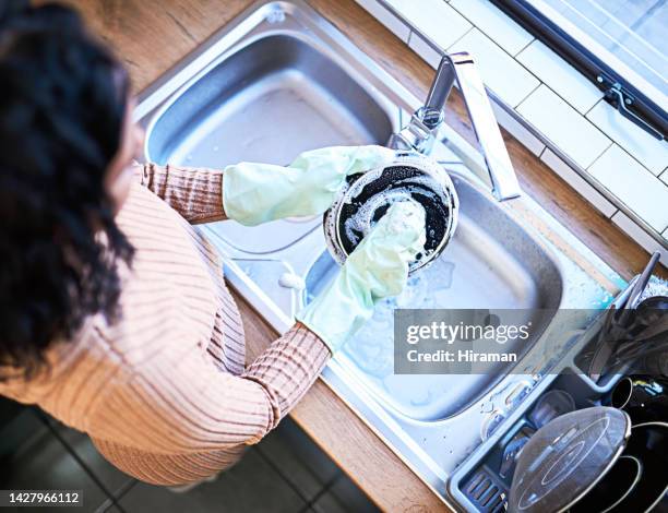 cleaning, kitchen and dishes with a woman cleaner holding a clean dish in a sink at home alone. washing, hygiene and gloves with a female homemaker keeping her house neat and tidy from above - latex 個照片及圖片檔