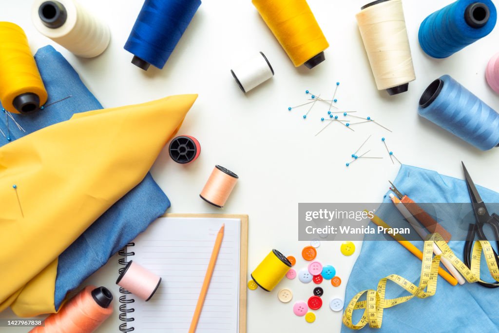 Top view designer fashion items and equipment material for work designer in the showroom. Mannequins stylish tailor measurements and cloth rail background.