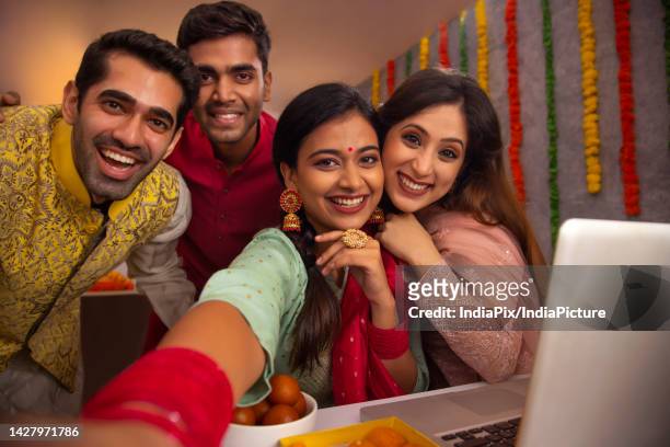 colleagues taking selfie together in office during diwali celebration - gulab jamun stock pictures, royalty-free photos & images