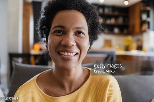 close up portrait of mid adult woman at home - black population stock pictures, royalty-free photos & images
