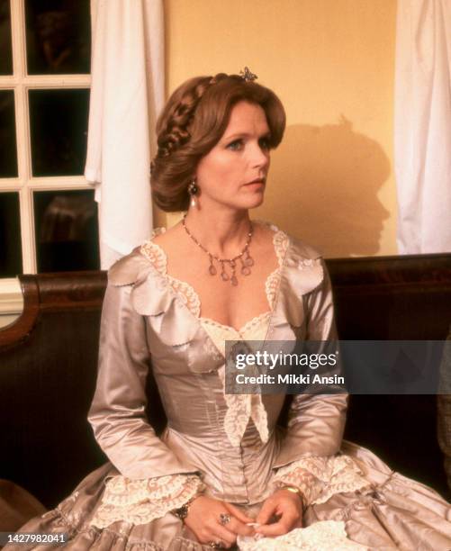 View of American actress Lee Remick as she sits on a couch on the set of 'The Europeans' , New Ipswich, New Hampshire, September 1978.