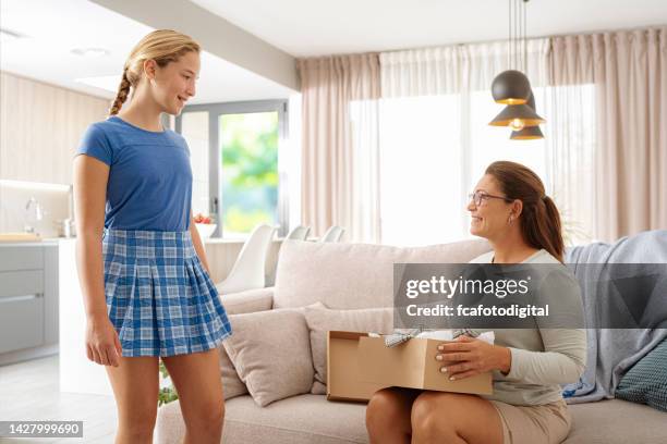 girl trying on clothes delivered at home - unboxing kid stock pictures, royalty-free photos & images