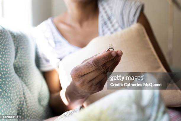 black woman holds diamond engagement ring - black women engagement rings stock pictures, royalty-free photos & images