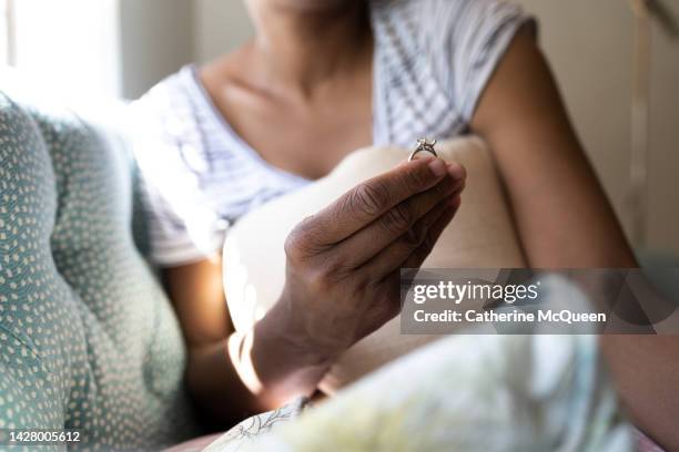 black woman holds diamond engagement ring - obesvarad kärlek bildbanksfoton och bilder