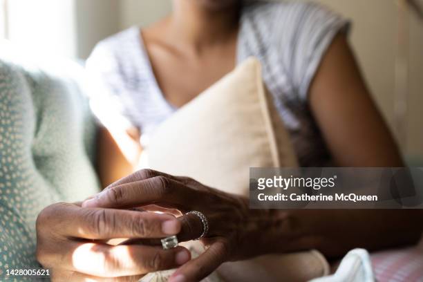 black woman holds diamond engagement ring - black women engagement rings foto e immagini stock