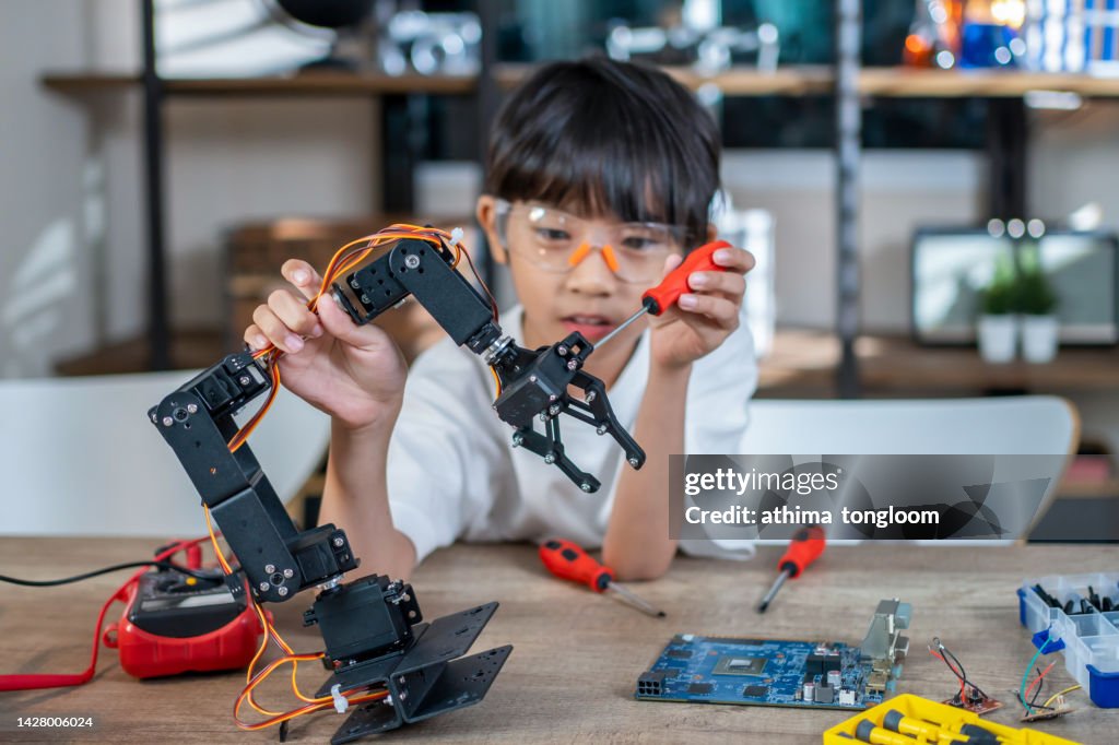 Child Inventing A Smart Kid Inventor Of Robot Arm High-Res Stock Photo - Getty Images