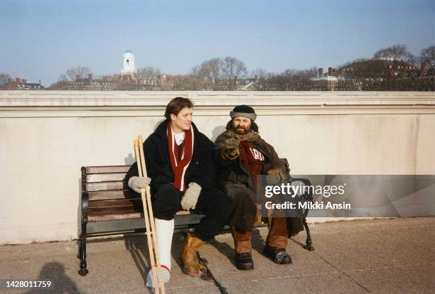 Actors Bendan Fraser and Joe Pesci sit on a bench on the John Weeks Footbridge during the filming of 'With Honors' , Cambridge, Massachusetts, March...