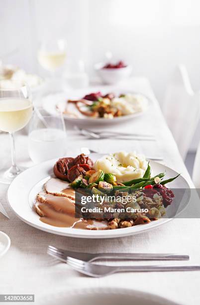 table set with turkey meal and white wine - thanksgiving plate of food stock pictures, royalty-free photos & images