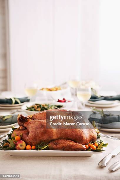 table set for meal with turkey dish - christmas turkey fotografías e imágenes de stock