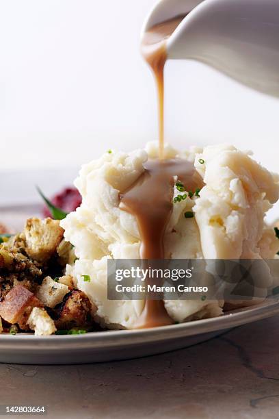 gravy being poured onto mashed potatoes - mashed potatoes stock pictures, royalty-free photos & images