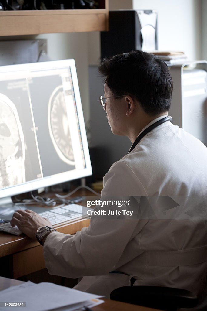 Doctor looking at x-ray on computer