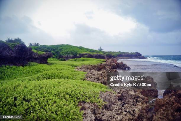scenic view of sea against sky,inarajan,guam - inarajan stock pictures, royalty-free photos & images