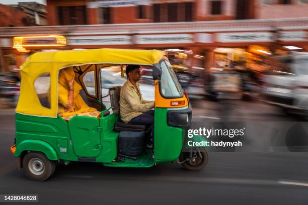 indian man drives auto rickshaw (tuk-tuk), india - jinrikisha stock pictures, royalty-free photos & images