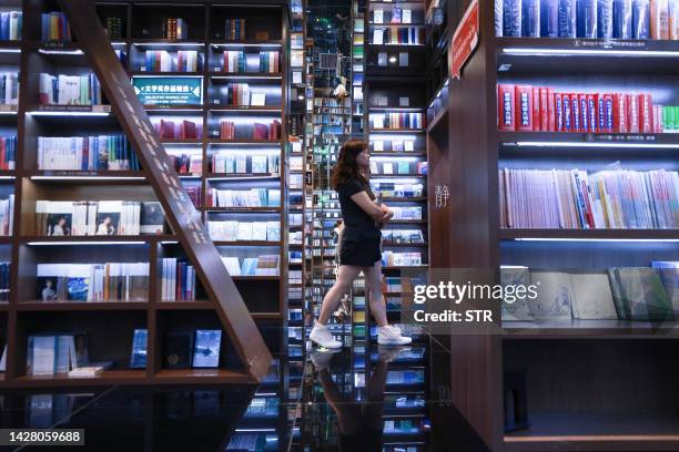 This photo taken on July 2, 2023 shows a woman visiting a book store in Guiyang, in China's southwestern Guizhou province. / China OUT