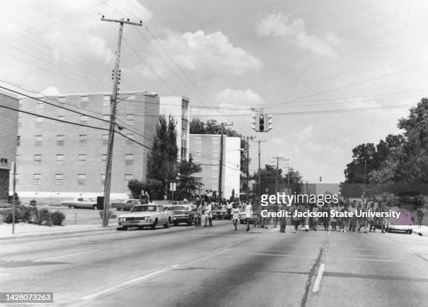 Seven thousand people attended the funeral of James Earl Green held at the Masonic Temple. Here they March by Alexander's "bullet riddled" Hall on...