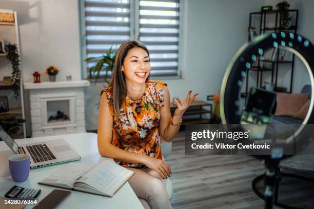 smiling woman filming a educational video on her phone with ring light - ring light stock pictures, royalty-free photos & images