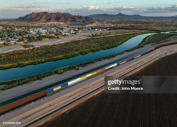 In this aerial view, shipping containers bridge previous gaps in the U.S.-Mexico border wall on September 27, 2022 in Yuma, Arizona. Some gaps in the...