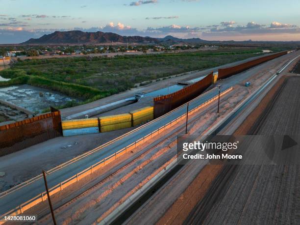 In this aerial view, shipping containers fill a previous gap in the U.S.-Mexico border wall on September 27, 2022 in Yuma, Arizona. Some gaps in the...