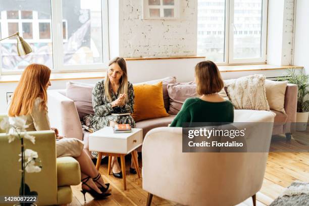 three women in armchairs and talking. reflection in the mirror - emotional support at work stock pictures, royalty-free photos & images