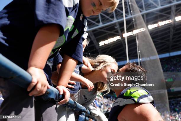 Austin Blythe of the Seattle Seahawks kisses his family before the game against the Atlanta Falcons at Lumen Field on September 25, 2022 in Seattle,...