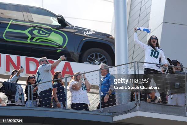 Sue Bird raises the 12th man flag before the game between the Seattle Seahawks and the Atlanta Falcons at Lumen Field on September 25, 2022 in...