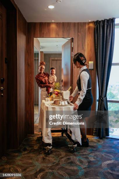 wealthy family ordering room service. - room service stock pictures, royalty-free photos & images