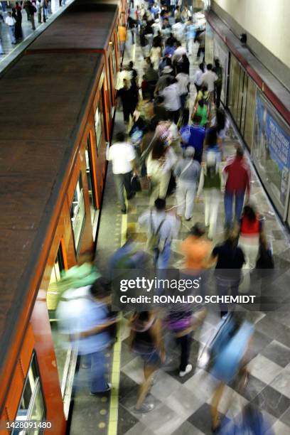 Commuters disembark from the train at Chapultepec subway station 13 October, 2007 in Mexico City. Mexico City's subway system has 175 stations along...