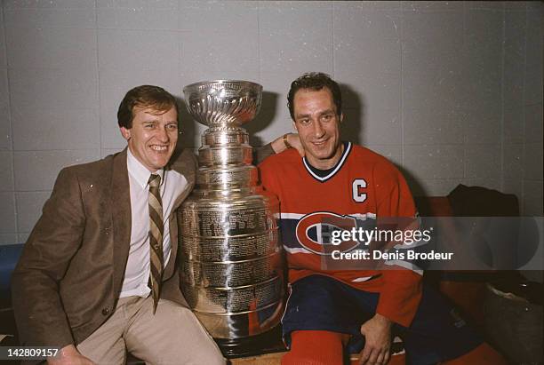 Head Coach Jean Perron of the Montreal Canadiens and Bob Gainey of the Montreal Canadiens pose for a photo with the Stanley Cup at the Montreal Forum...