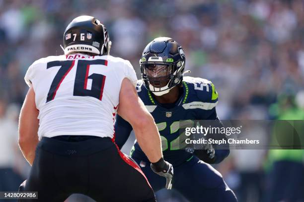 Darrell Taylor of the Seattle Seahawks in action against Kaleb McGary of the Atlanta Falcons during the second quarter at Lumen Field on September...