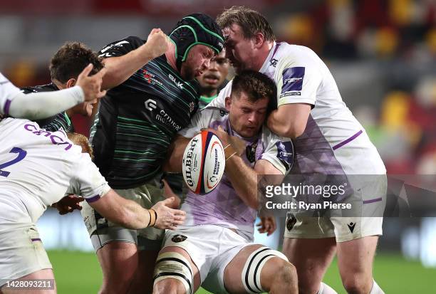 Sam Graham of Northampton Saints is tackled by Ciaran Parker of London Irish during the Premiership Rugby Cup match between London Irish and...
