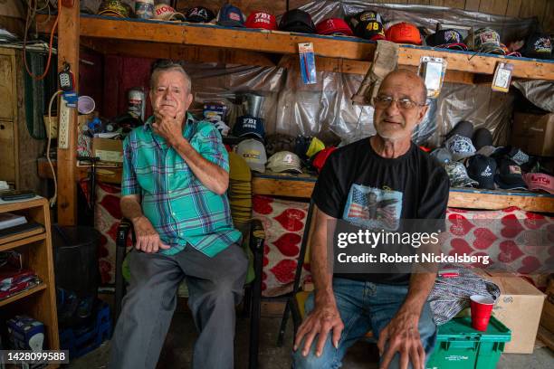 The owner of Roberts Gift Store, left, sits with his younger brother in their gift store August 27, 2022 in Montcalm, West Virginia. The mens father...